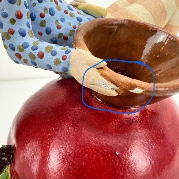 CARRIANNE L HENDRICKSON woman with beak hat sitting on apple sculpture 2… - Picture 11 of 16